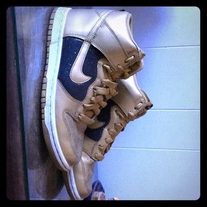 Black and gold Nike high tops